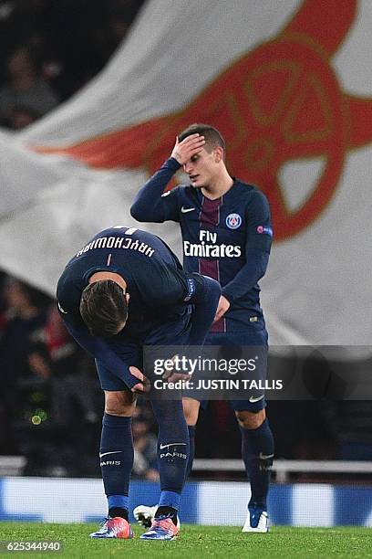 Paris Saint-Germain's Italian midfielder Marco Verratti reacts after scoring an own goal for Arsenal's second goal during the UEFA Champions League...