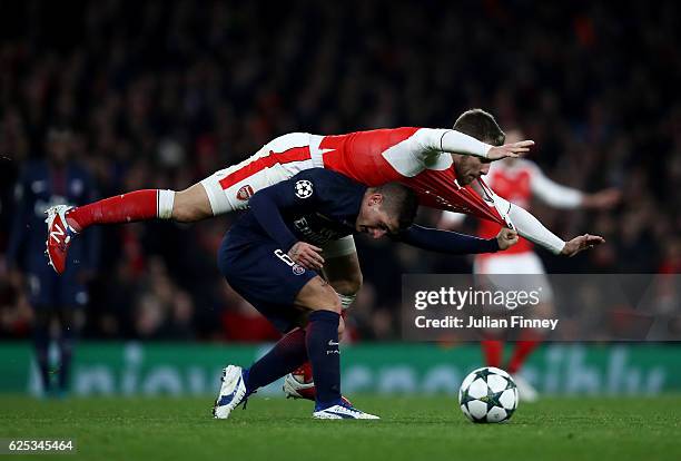 Aaron Ramsey of Arsenal fouls Marco Verratti of PSG during the UEFA Champions League Group A match between Arsenal FC and Paris Saint-Germain at the...