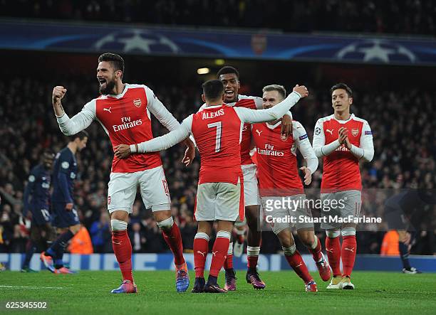 Alexis Sanchez and Olivier Giroud celebrate the 2nd Arsenal goal during the UEFA Champions League match between Arsenal FC and Paris Saint-Germain at...