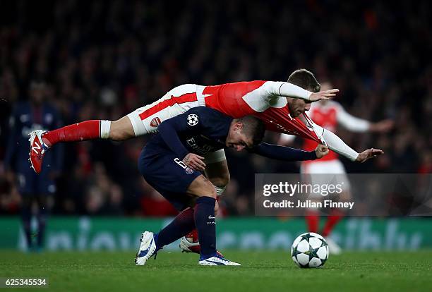 Aaron Ramsey of Arsenal fouls Marco Verratti of PSG during the UEFA Champions League Group A match between Arsenal FC and Paris Saint-Germain at the...