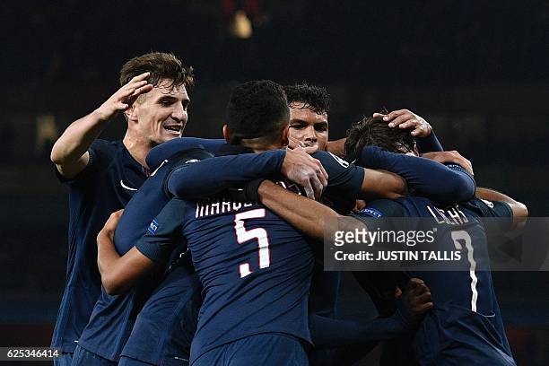 Paris Saint-Germain's Brazilian midfielder Lucas Moura celebrates with his team-mates after scoring their second goal to equalise 2-2 during the UEFA...