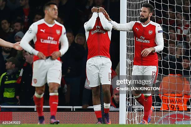 Arsenal's Nigerian striker Alex Iwobi reacts after deflecting the ball from Paris Saint-Germain's Brazilian midfielder Lucas Moura's header for...