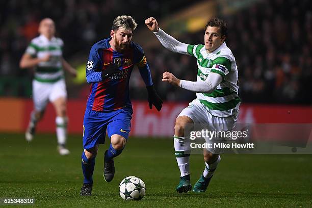 Lionel Messi of Barcelona gets past Erik Sviatchenko of Celtic during the UEFA Champions League Group C match between Celtic FC and FC Barcelona at...