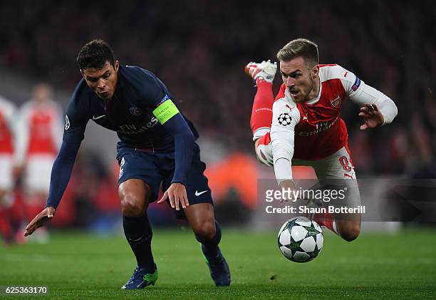 Aaron Ramsey of Arsenal and Thiago Silva of PSG battle for possession during the UEFA Champions League match between Arsenal FC and Paris...