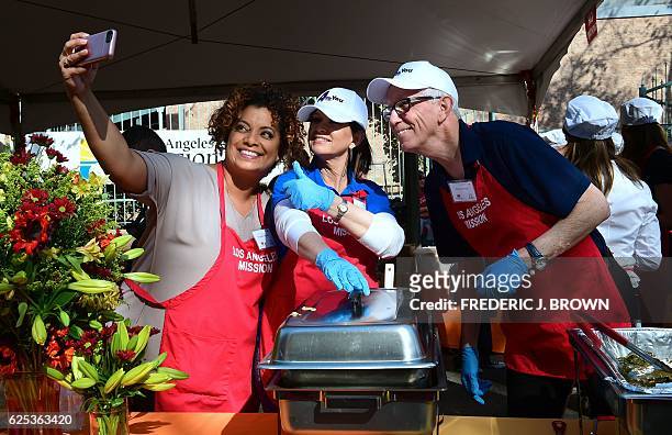 Michaela Pereira , Colleen Williams and Fritz Coleman snap a selfie between serving at the Los Angeles Mission in Los Angeles, California on November...