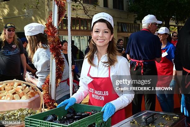 Actress Masiela Lusha helps out as a volunteer at the Los Angeles Mission in Los Angeles, California on November 23 where up to 3,500 people are fed...