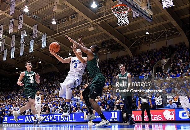 Daniel Dixon of the William & Mary Tribe defends a shot by Grayson Allen of the Duke Blue Devils during the game at Cameron Indoor Stadium on...