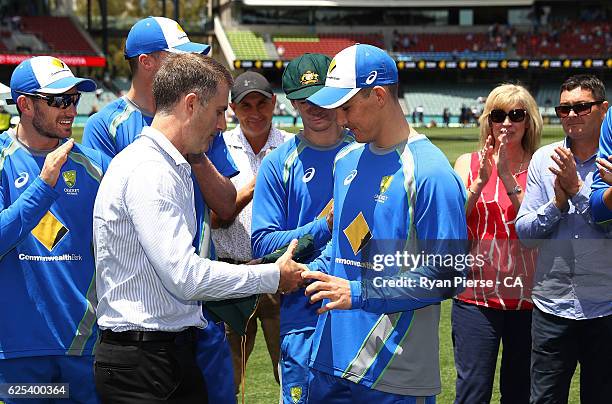 Nic Maddinson of Australia recieves his Baggy Green Cap from former Test Cricketer Simon Katich during day one of the Third Test match between...