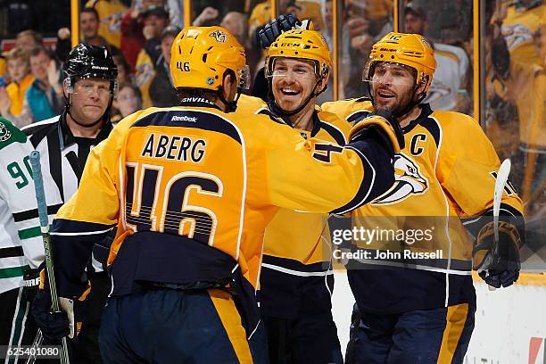 Mike Fisher celebrates his goal with Colin Wilson and Pontus Aberg of the Nashville Predators against the Dallas Stars during an NHL game at...