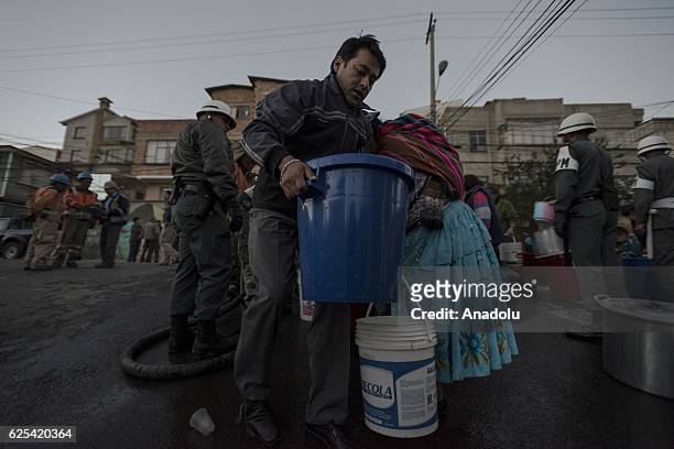 Man collects water in a bucket from a water well near his house in a residential area affected by the lack of water in the city of La Paz, Bolivia on...