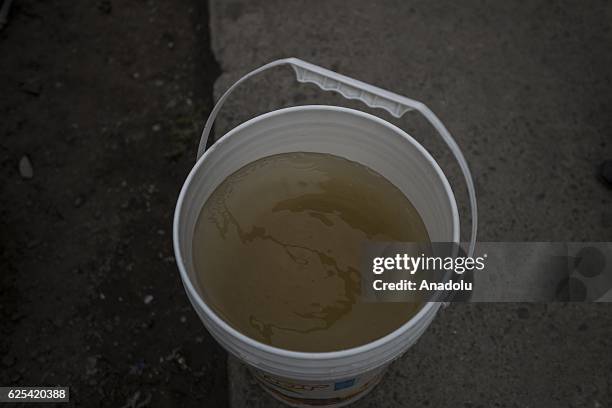 View of a bucket with water delivered by a water truck in a residential area affected by the lack of water in the city of La Paz, Bolivia on November...