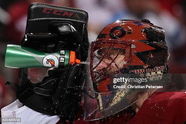 Goaltender Mike Smith of the Arizona Coyotes sprays water in his face after giving up a goal to the Vancouver Canucks during the second period of the...