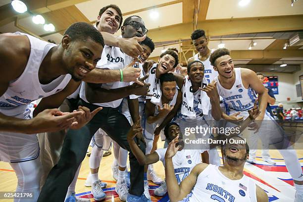 The North Carolina Tar Heel players pose for a photo after winning the championship game of the Maui Invitational against the Wisconsin Badgers at...