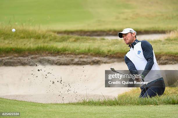 Chris Wood of England plays out of the bunker during day one of the World Cup of Golf at Kingston Heath Golf Club on November 24, 2016 in Melbourne,...