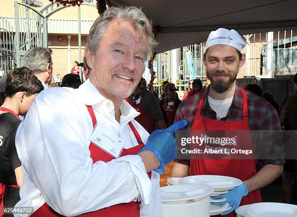 Actors John Savage and Tom Payne at the Los Angeles Mission Thanksgiving Meal For The Homeless held at Los Angeles Mission on November 23, 2016 in...