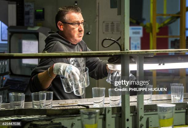 An employee works in the Arc glass factory in Arques, northern France, on November 23, 2016.