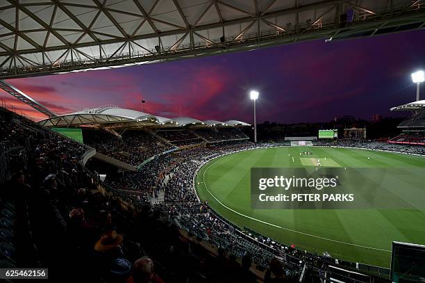The sun sets during the first innings of the day-night third Test cricket match between Australia and South Africa at the Adelaide Oval in Adelaide...