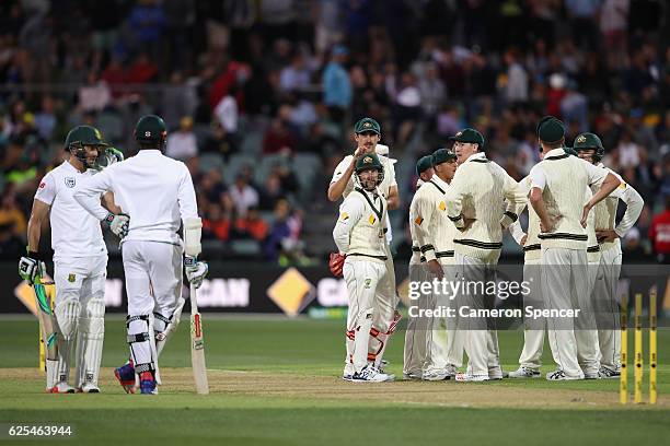 Matthew Wade of Australia looks at Kagiso Rabada of South Africa after stumping him out of his crease during day one of the Third Test match between...