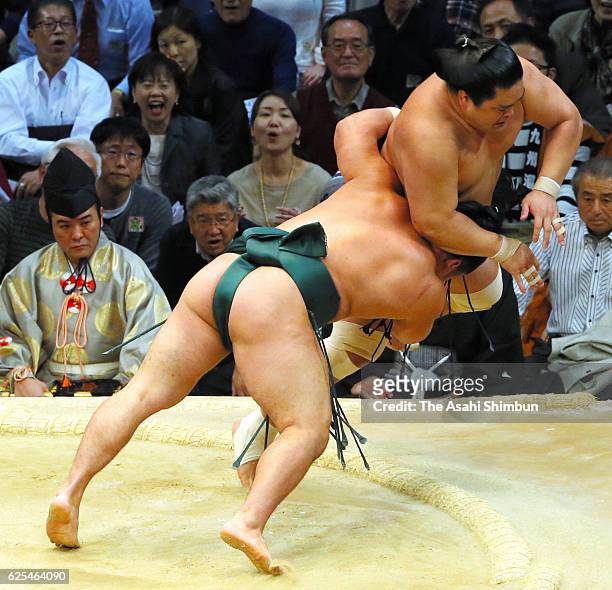 Ishiura throws Myogiryu to win during day eleven of the Grand Sumo Kyushu Tournament at Fukuoka Convention Center on November 23, 2016 in Fukuoka,...