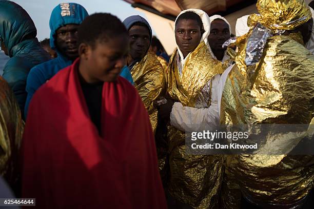 Refugees wait to disembark the MOAS vessel "Topaz Responder" on November 24, 2016 in Vibo Valentia, Italy. The MOAS team worked through the night of...