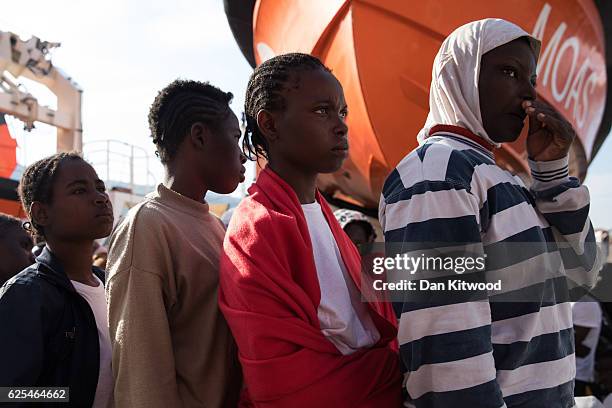 Refugees wait to disembark the MOAS vessel "Topaz Responder" on November 24, 2016 in Vibo Valentia, Italy. The MOAS team worked through the night of...