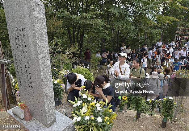 Japan - Relatives of victims of the 1985 Japan Airlines jumbo jet crash pay their respects at the memorial monument at the crash site called Osutaka...