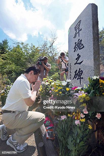 Japan - Japan Airlines Co. President Yoshiharu Ueki puts his hands together at a cenotaph at the site of the 1985 JAL jumbo jet crash on Osutaka...