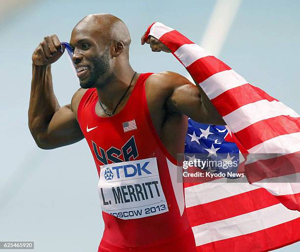 Russia - LaShawn Merritt of the United States celebrates with the U.S. National flag after winning the men's 400 meters with a time of 43.74 seconds...