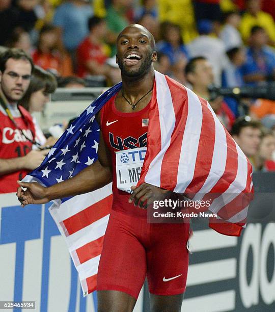 Russia - LaShawn Merritt of the United States celebrates with the U.S. National flag after winning the men's 400 meters with a time of 43.74 seconds...