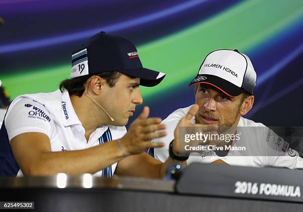 Jenson Button of Great Britain and McLaren Honda and Felipe Massa of Brazil and Williams talk in their final Drivers Press Conference before their...