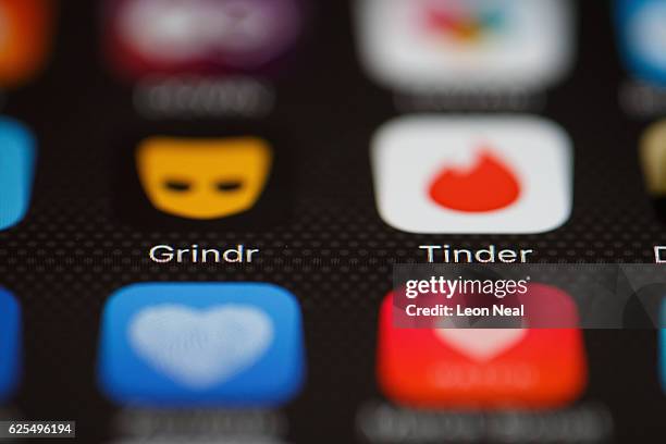 The "Grindr" and "Tinder" app logos are seen on a mobile phone screen on November 24, 2016 in London, England. Following a number of deaths linked to...