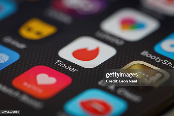 The "Tinder" app logo is seen amongst other dating apps on a mobile phone screen on November 24, 2016 in London, England. Following a number of...