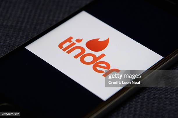 The "Tinder" app logo is seen on a mobile phone screen on November 24, 2016 in London, England. Following a number of deaths linked to the use of...