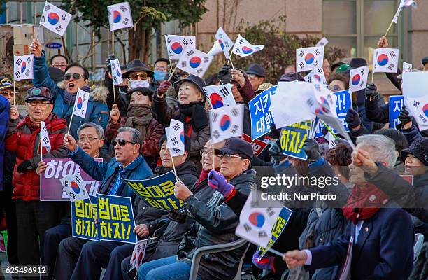 South Korean conservative protesters hold flyer with shout slogans during their President Park Geun Hye resigned oppose rally at Seoul station square...