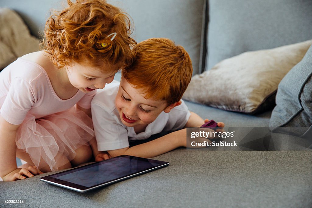 Siblings Sharing Digital Tablet