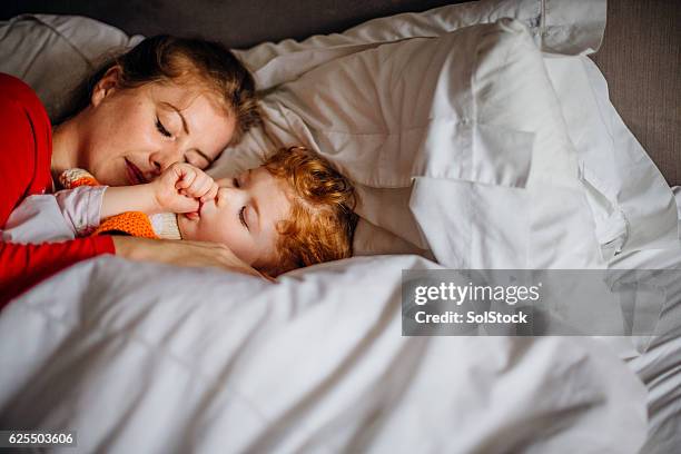 naptime with mum - thumb sucking stock pictures, royalty-free photos & images