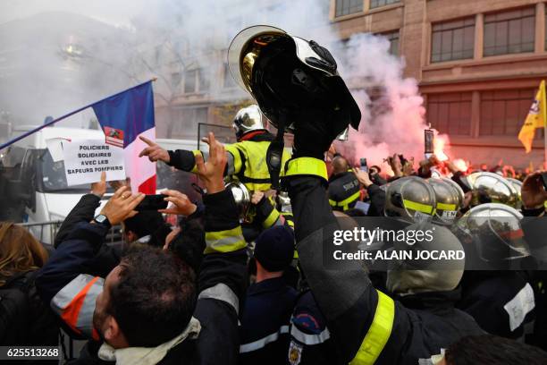 Firefighters face a police blockade outside the Interior Ministry's Garance building near Place de la Nation in Paris on November 24, 2016 during a...