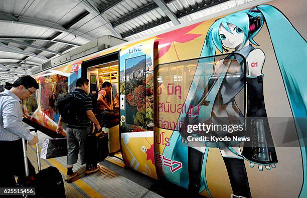 Thailand - Passengers board a train in Bangkok painted with an illustration of Hatsune Miku, a popular Japanese character, on Aug. 16, 2013. The...