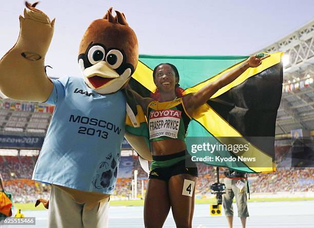 Russia - Shelly-Ann Fraser-Pryce of Jamaica carries the Jamaican national flag after winning the women's 200 meters at the world athletics...