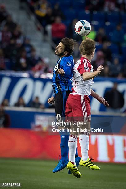 Midfielder Hernán Bernardello of the Montreal Impact goes up for the ball against Captain Dax McCarty of the New York Red Bulls during the second leg...