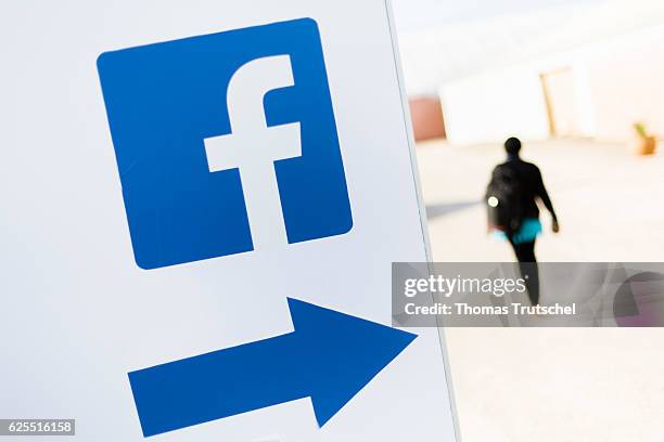 Marrakesch, Morocco A person passes a logo of the social media platform Facebook on November 15, 2016 in Marrakesch, Morocco.