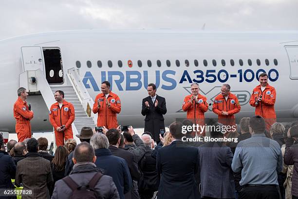 Fabrice Bregier, chief executive officer of the commercial aircraft unit at Airbus Group, center, stands with the aircrew of the A350-1000 twinjet...