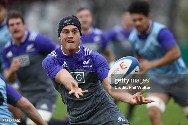 Israel Dagg of the New Zealand All Blacks offloads during a training session at the Suresnois Rugby Club on November 24, 2016 in Paris, France.