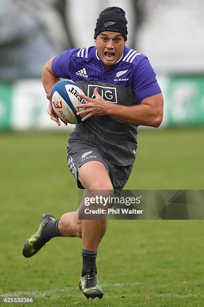 Israel Dagg of the New Zealand All Blacks runs with the ball during a training session at the Suresnois Rugby Club on November 24, 2016 in Paris,...