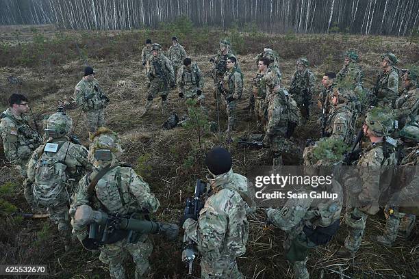 Members of the U.S. 173rd Airborne Brigade discuss the outcome of a simulated attack during the Iron Sword multinational military exercises on...