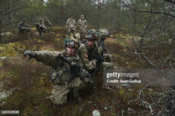 Members of the U.S. 173rd Airborne Brigade prepare a simulated attack during the Iron Sword multinational military exercises on November 24, 2016...