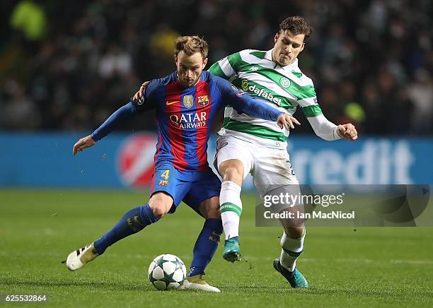 Ivan Rakitic of Barcelona vies with Erik Sviatchenko of Celtic during the UEFA Champions League match between Celtic FC and FC Barcelona at Celtic...