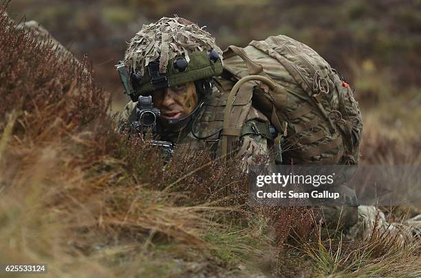 Member of the British Army 1st Battalion of The Mercian Regiment maintains a defensive position prior to a simulated attack during the Iron Sword...