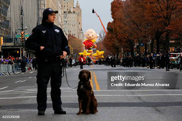 Officer stands stand guard with his dog during the 90th Macy's Annual Thanksgiving Day Parade on November 24, 2016 in New York City. Security was...