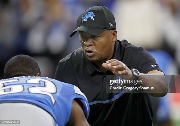 Head Coach head coach Jim Caldwell of the Detroit Lions warms up with Antwione Williams of the Detroit Lions prior to the start of their game against...